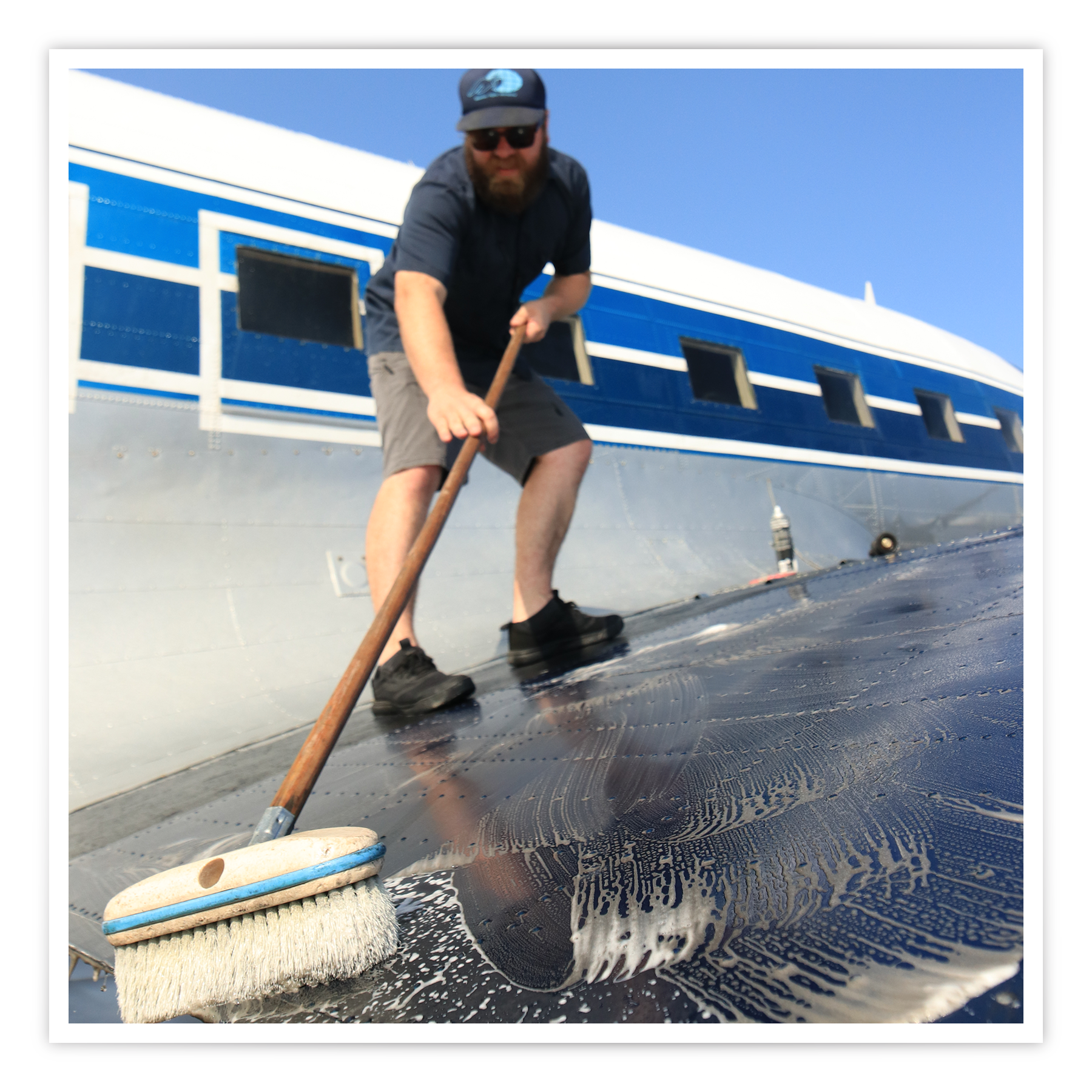 MFI Maintenance Specialist, Drew Aungst, cleans the DC-3 during a period of decreased flights.